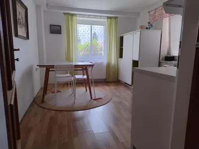 a small kitchen with a table and a refrigerator at Apartmán Sofie in Poděbrady