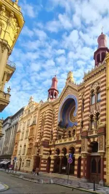 a large building with two towers on a street at Just Steps from Wenceslas Square! in Prague