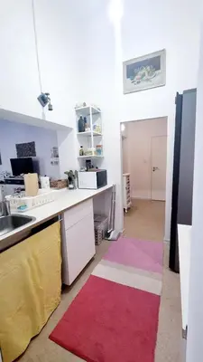 a kitchen with a sink and a counter with colorful rugs at Just Steps from Wenceslas Square! in Prague