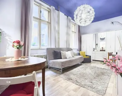 a living room with a couch and a table at Just Steps from Wenceslas Square! in Prague