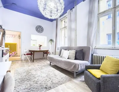 a living room with a couch and a chandelier at Just Steps from Wenceslas Square! in Prague
