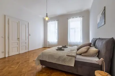 a living room with a bed and a couch at Designový Apartmán in Prague