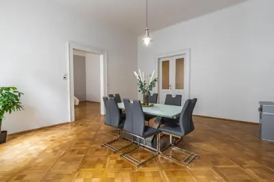 a dining room with a table and black chairs at Designový Apartmán in Prague