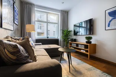 a living room with a couch and a tv at Stylish Apartment in Prague's Historic Centre in Prague