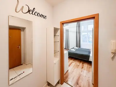 a room with a mirror and a bedroom with a bed at MIVA apartments in Prague