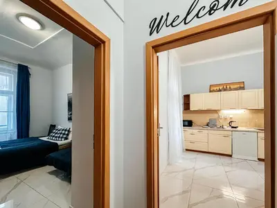 a living room with a door leading to a kitchen at MIVA apartments in Prague