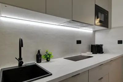 a kitchen with a sink and a microwave at CityMood Prague Apartment in Prague