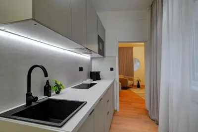 a kitchen with a sink and a counter top at CityMood Prague Apartment in Prague