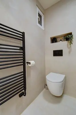 a bathroom with a white toilet in a room at CityMood Prague Apartment in Prague