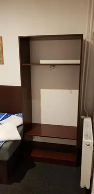 a closet in a room with a bed and a bed sqor at Pension & Restaurace Na Rychtě in Prague