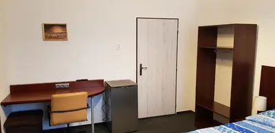 a room with a desk and a bed and a deskictericter at Pension & Restaurace Na Rychtě in Prague