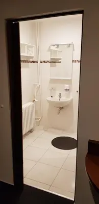 a small bathroom with a sink and a toilet at Pension & Restaurace Na Rychtě in Prague