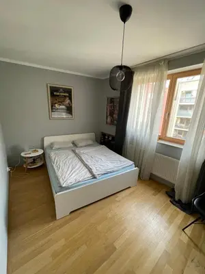 a bedroom with a white bed in a room at COSY&SUNNY flat, center 10min, park 3min, baby cot, free weekend parking in Prague