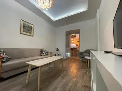 a living room with a couch and a table at Urban Zen Apartment in Prague