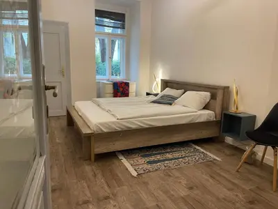 a bedroom with a bed and a window at Urban Zen Apartment in Prague