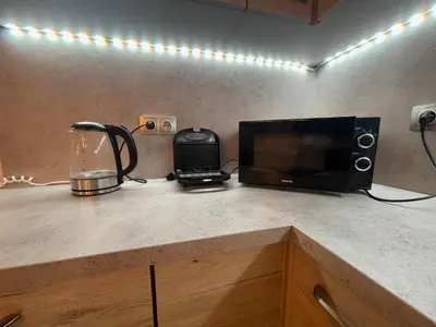 a kitchen counter with a microwave and a blender at Urban Zen Apartment in Prague