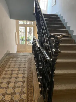 a stairway with a wrought iron railing and a set of stairs at Urban Zen Apartment in Prague