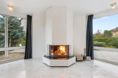 a kitchen with white cabinets and black counter tops at Black Dragon Haven Luxury Villa with Pool, Sauna & Jacuzzi in Prague