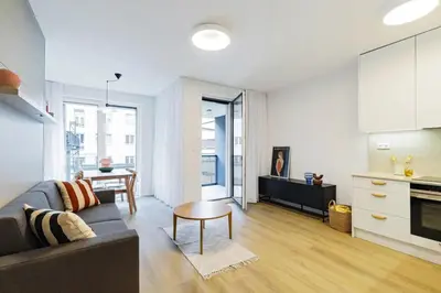 a living room with a couch and a table at ANIMA Home, free parking in Prague