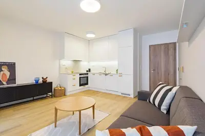 a living room with a couch and a table at ANIMA Home, free parking in Prague