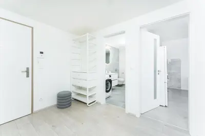 a white room with a staircase and a mirror at Rentero Warm & Cozy Stay in Prague, By the River in Prague