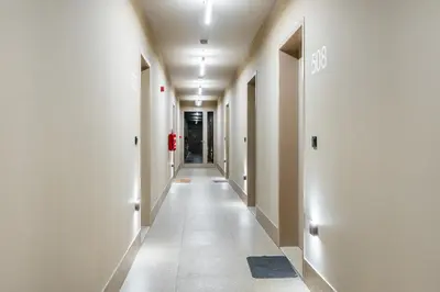 an empty hallway with white walls and white floors at Rentero Warm & Cozy Stay in Prague, By the River in Prague