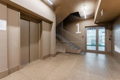 a hallway with a staircase in a building at Rentero Warm & Cozy Stay in Prague, By the River in Prague