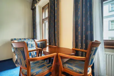a dining room with a table and chairs and a window at Cozy Historic City Centre Studio by Rentez in Prague