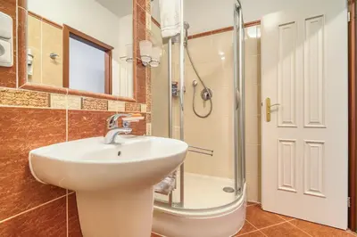 a bathroom with a sink and a shower at Cozy Historic City Centre Studio by Rentez in Prague