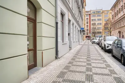 an empty street in a city with parked cars at Cozy Historic City Centre Studio by Rentez in Prague