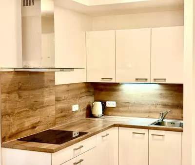 a kitchen with white cabinets and a sink at My Sweet Home - Zakšínská - Prague in Prague