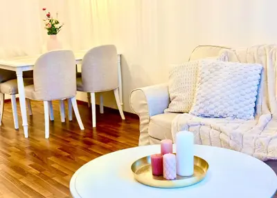 a living room with a couch and a table with candles at My Sweet Home - Zakšínská - Prague in Prague