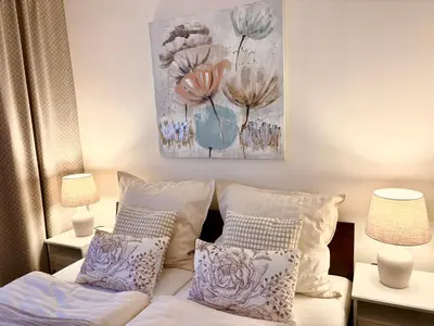 a bedroom with a bed with pillows and a painting on the wall at My Sweet Home - Zakšínská - Prague in Prague