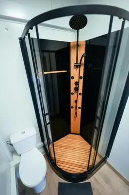 a bathroom with a shower with a toilet in it at ermiglamping in Jince