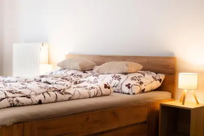 a bed with two pillows on top of it at Apartmán IRIS Poděbrady 2 in Poděbrady
