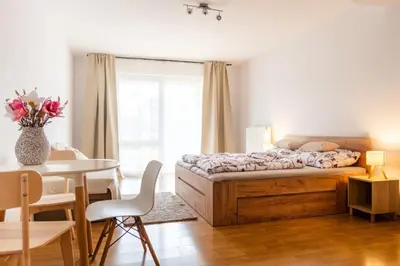 a bedroom with a bed and a table and a dining room at Apartmán IRIS Poděbrady 2 in Poděbrady
