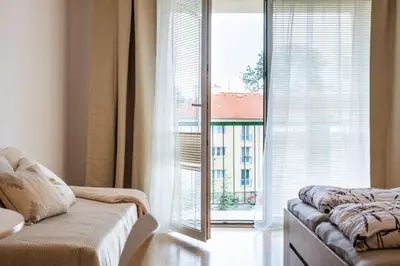 a living room with a couch and a large window at Apartmán IRIS Poděbrady 2 in Poděbrady