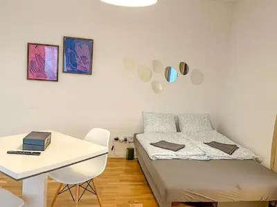 a small bedroom with a bed and a desk at Serene Apartment near Wenceslas Sq & Main Station in Prague