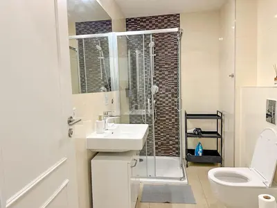 a bathroom with a shower and a sink and a toilet at Serene Apartment near Wenceslas Sq & Main Station in Prague