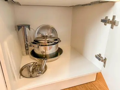 a kitchen with two pots and pans on a shelf at Serene Apartment near Wenceslas Sq & Main Station in Prague