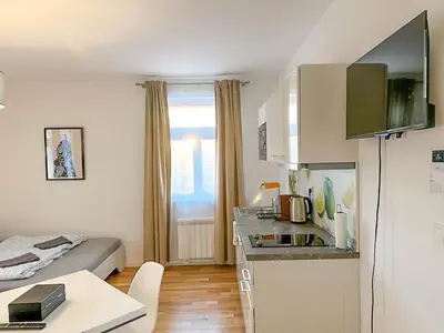 a small apartment with a bed and a kitchen at Serene Apartment near Wenceslas Sq & Main Station in Prague