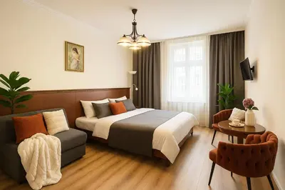 a hotel room with a bed and a couch at HOMELYI 28m2 Central studio with ELEVATOR and SELF CHECK-IN in Prague