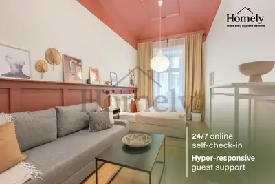 a living room with a couch and a bedroom at HOMELYI 28m2 Central studio with ELEVATOR and SELF CHECK-IN in Prague