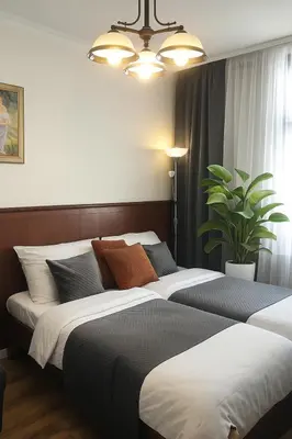 a bedroom with two beds and a potted plant at HOMELYI 28m2 Central studio with ELEVATOR and SELF CHECK-IN in Prague