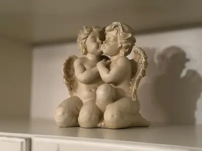 a statue of two angels kissing on a table at 2 BR Designer Apartment in Old Town in Prague