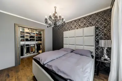 a bedroom with a large bed and a chandelier at 2 BR Designer Apartment in Old Town in Prague