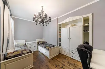 a room with white cabinets and a chandelier at 2 BR Designer Apartment in Old Town in Prague