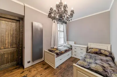 a bedroom with two beds and a chandelier at 2 BR Designer Apartment in Old Town in Prague