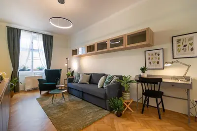 a living room with a couch and a table at Residence I at Havel's Market in Prague