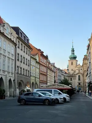 a row of cars parked on a city street at Residence I at Havel's Market in Prague